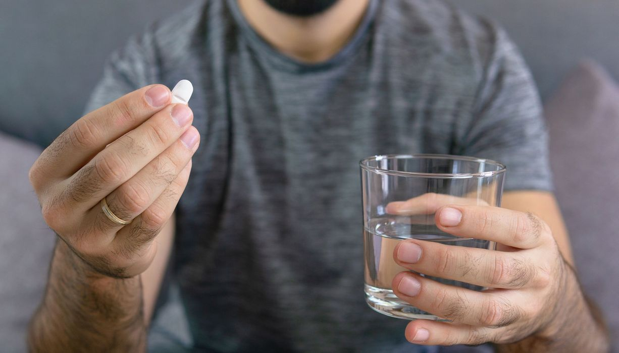 Orlistat 120 mg capsules voor gewichtsverlies naast een glas water